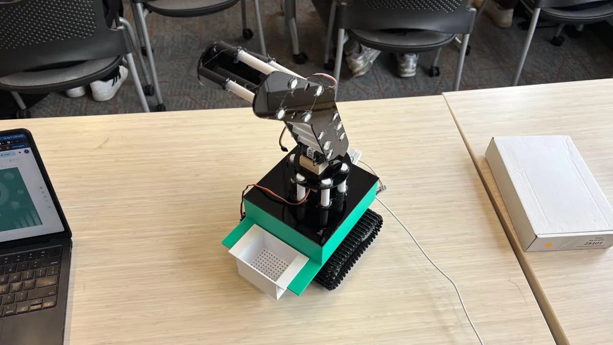 The first complete prototype: teal printed body on tracks, black acrylic top and arm, and a white perforated sifter tray.